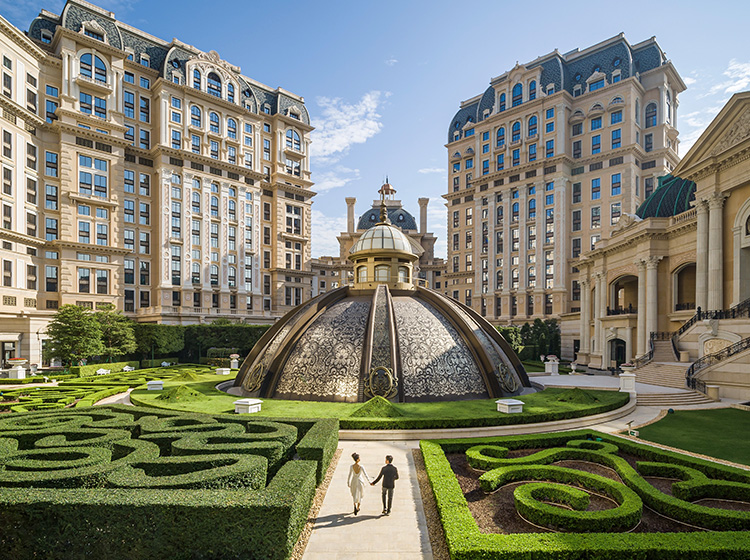 /A%20pair%20of%20couples%20are%20walking%20in%20Jardim%20Secreto%2C%20the%20European-styled%20garden%20located%20at%20GLP%20Resort%20Macau.